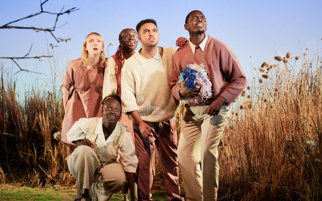 Production photo of Against The Tide - five actors in soft pastel clothes look out into the audience.