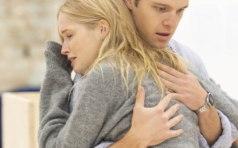 Jasper Talbot holds Ellie Bamber. She cries with her head on his shoulder. He has a worried expression.