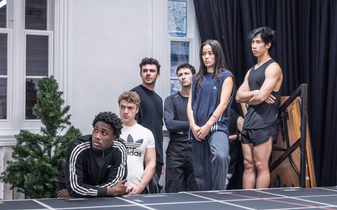 Daniel Bravo, Jack Butterworth, Hannah Yun Chamberlain, Alex James-Hatton, Posi Morakinyo, and Zheng Xi Yong stand together in a rehearsal room.