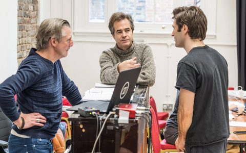 Rupert Goold, Arty Froushan and David Shrubsole stand in the rehearsal room, in conversation.