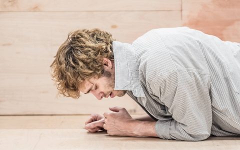 Jack Riddiford lies facing the ground with his head hung.
