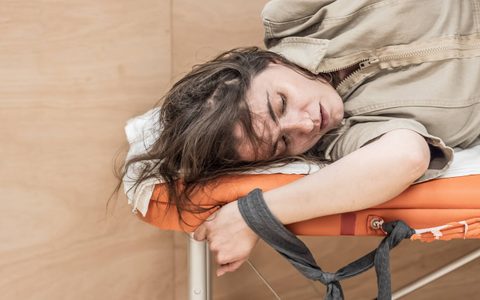 Pearl Chanda lies strapped to an orange doctor's bed.