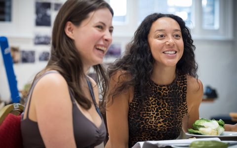 Agnes O’Casey and Adelle Leonce sit at a table. They are both smiling.