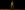 Josh O'Connor stands on a yellow floor, against a black background. His eyes are closed, and his left hand is partially splayed.