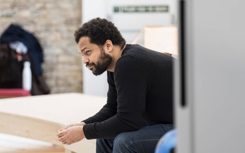 Olivier Huband sits deep in thought wearing a black jumper.