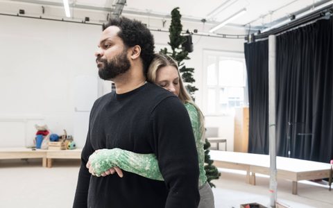 Romola Garai embraces Oliver Huband from behind in the rehearsal room.